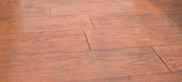 Pattern imprinted concrete surface resembling wood by PICS.