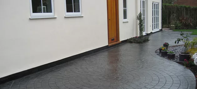 Pattern imprinted concrete driveway by PICS, enhancing curb appeal and durability with unique design.