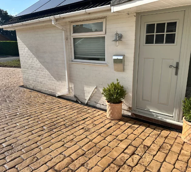 Pattern imprinted concrete driveway by PICS, enhancing curb appeal with durable design.